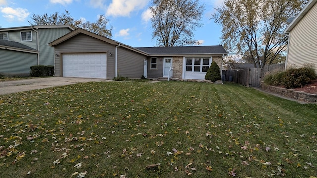 ranch-style home featuring a front yard, fence, an attached garage, concrete driveway, and stone siding