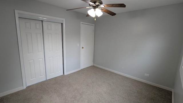 unfurnished bedroom featuring a closet, baseboards, a ceiling fan, and carpet flooring