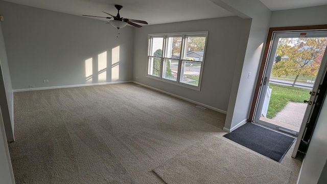 interior space with carpet floors and ceiling fan