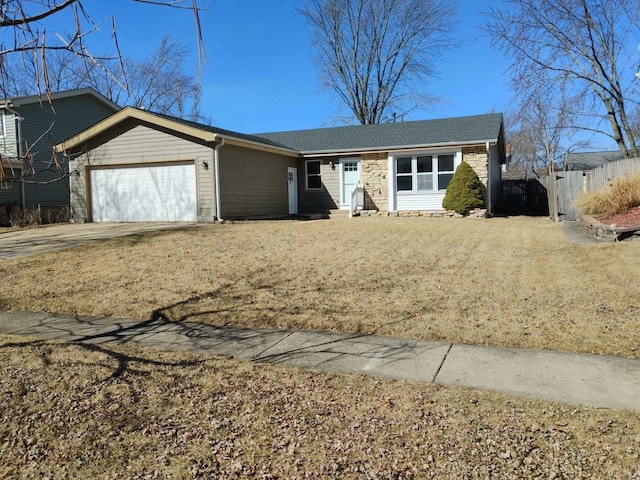 ranch-style home featuring a garage, driveway, and fence