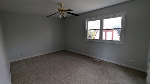 spare room with visible vents, baseboards, carpet floors, and a ceiling fan