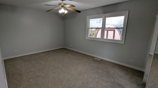 empty room featuring visible vents, carpet flooring, and baseboards