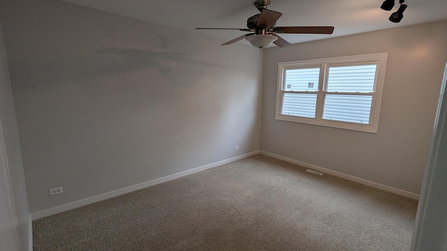 empty room with baseboards, light colored carpet, and a ceiling fan