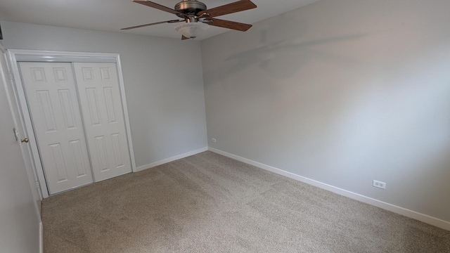 unfurnished bedroom featuring baseboards, carpet floors, a closet, and ceiling fan