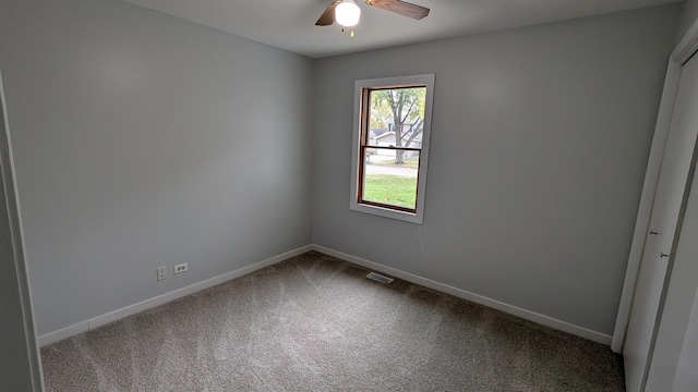 carpeted empty room featuring a ceiling fan, baseboards, and visible vents