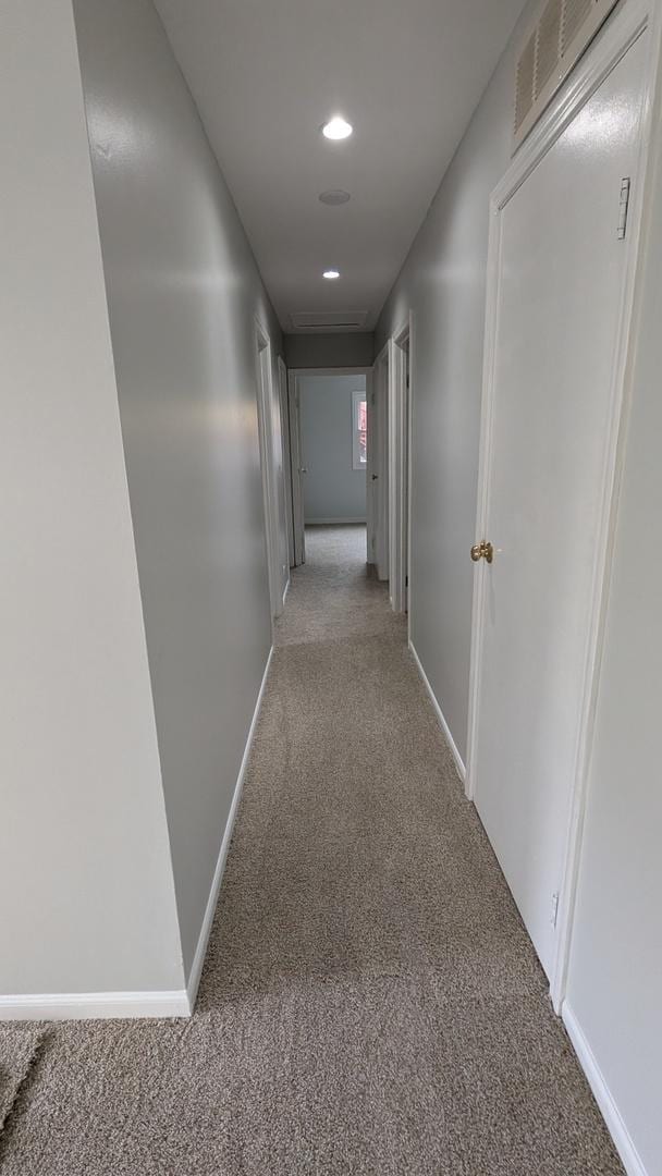 hall featuring recessed lighting, baseboards, visible vents, and carpet floors