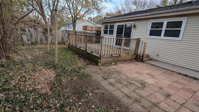 rear view of property with a patio, fence, and a wooden deck