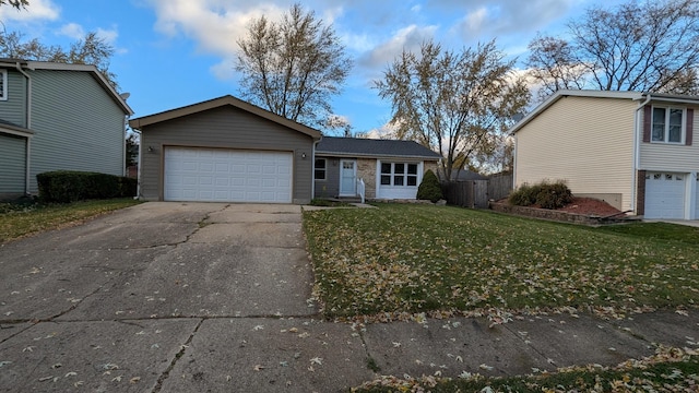 view of front facade featuring driveway, an attached garage, a front lawn, and fence