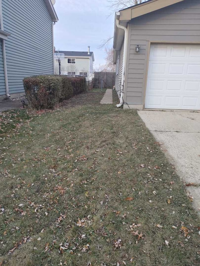 view of yard with a garage and fence