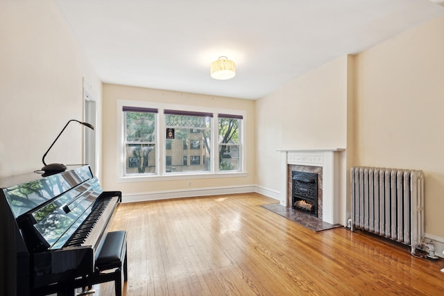 interior space with hardwood / wood-style flooring and radiator