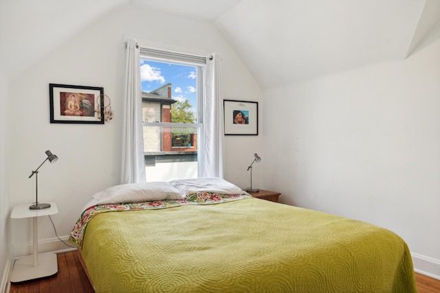 bedroom featuring hardwood / wood-style flooring and lofted ceiling