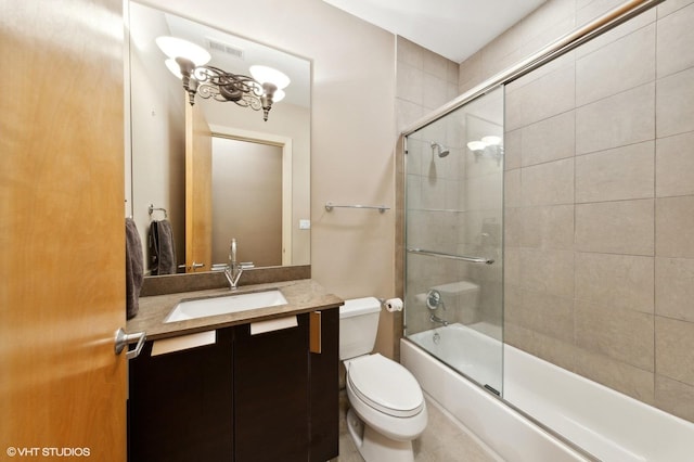 full bathroom featuring shower / bath combination with glass door, vanity, and toilet