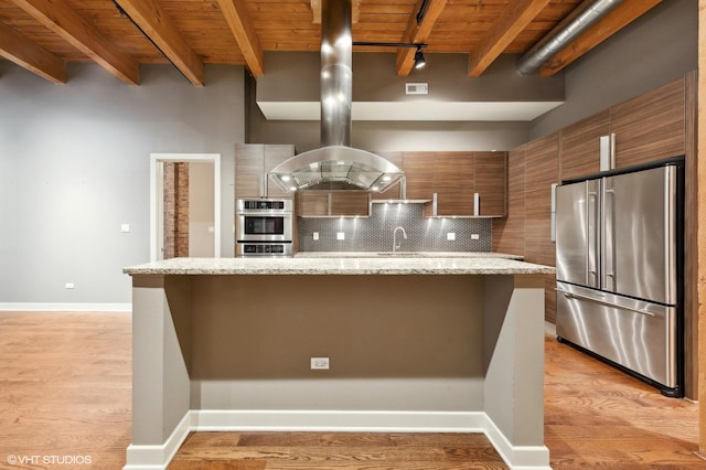 kitchen featuring beamed ceiling, stainless steel appliances, light hardwood / wood-style floors, and wood ceiling