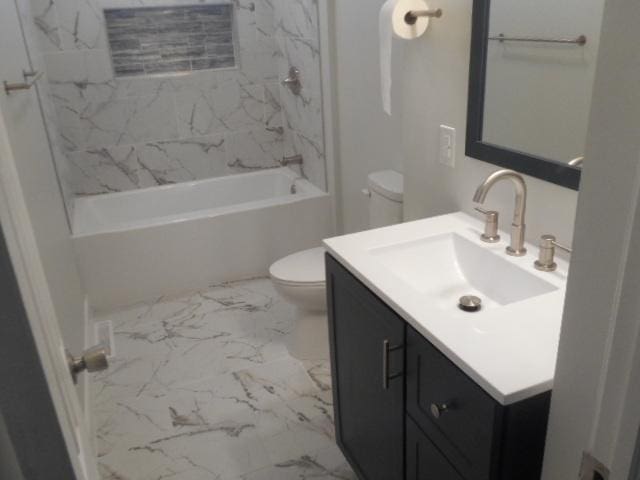 full bathroom with marble finish floor, tub / shower combination, vanity, and toilet