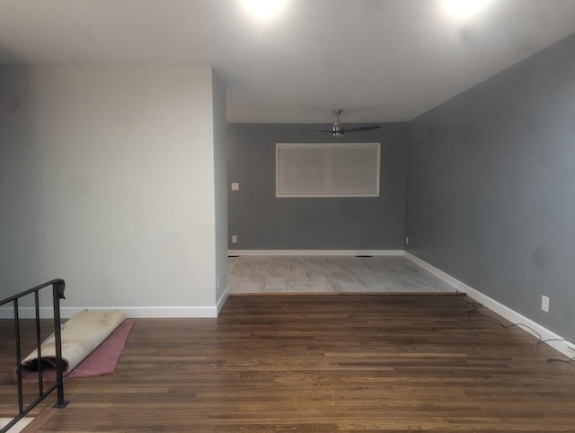 unfurnished room featuring a ceiling fan, baseboards, and wood finished floors