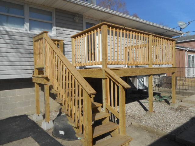 wooden deck featuring stairs