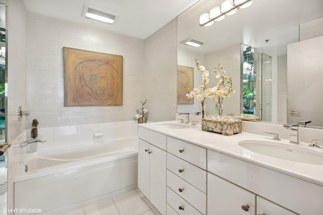 bathroom featuring tile patterned flooring, vanity, and shower with separate bathtub