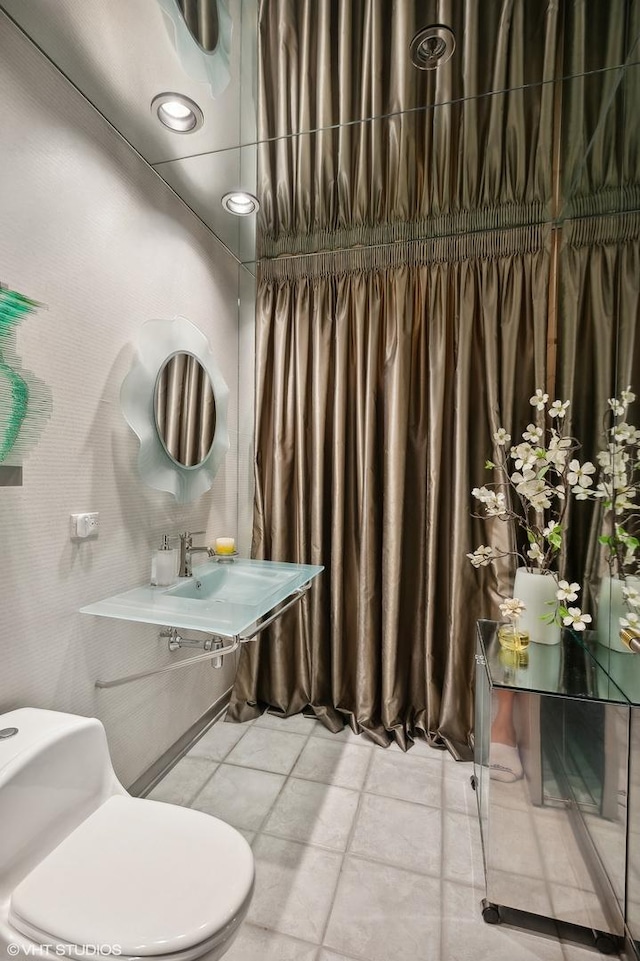 bathroom with sink, tile patterned flooring, and toilet