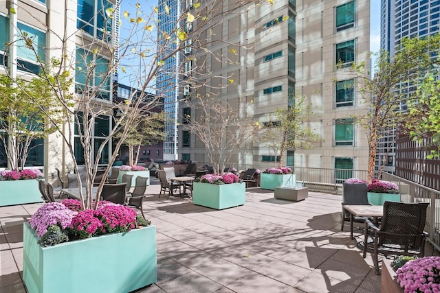 view of property's community with an outdoor living space and a patio area