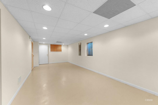 basement with a paneled ceiling