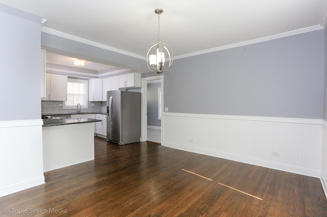 kitchen with hanging light fixtures, stainless steel fridge with ice dispenser, dark hardwood / wood-style flooring, a chandelier, and white cabinets