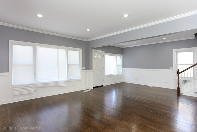 unfurnished living room with crown molding and dark wood-type flooring