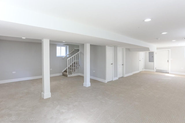 basement featuring electric panel and light colored carpet