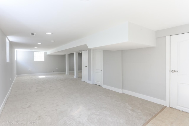 basement featuring light colored carpet