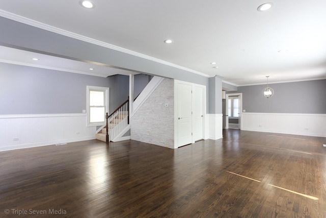 unfurnished living room with crown molding and dark hardwood / wood-style floors