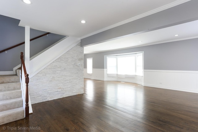 unfurnished living room featuring dark hardwood / wood-style floors and ornamental molding