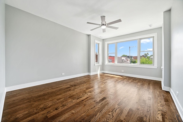 empty room featuring dark hardwood / wood-style floors and ceiling fan