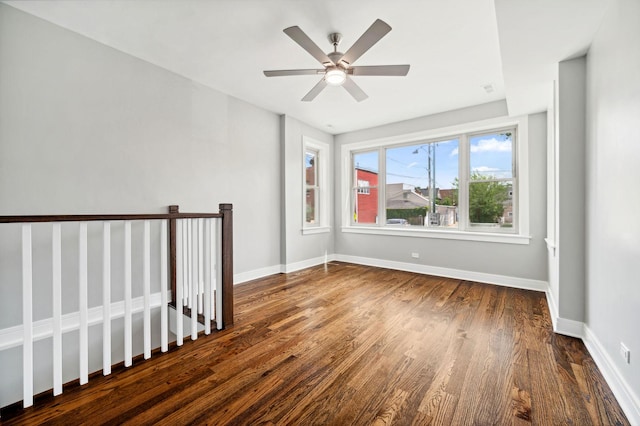 spare room with dark hardwood / wood-style floors and ceiling fan