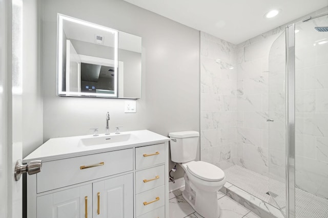 bathroom featuring vanity, toilet, and tiled shower