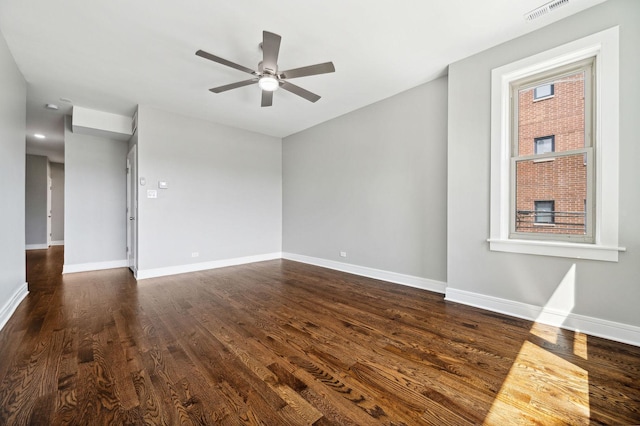 empty room featuring dark wood-type flooring and ceiling fan