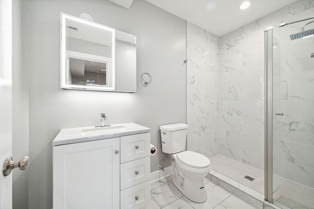 bathroom with vanity, toilet, and a shower with door