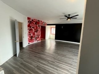 unfurnished room with hardwood / wood-style floors and ceiling fan