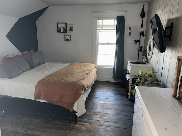 bedroom with dark wood-type flooring