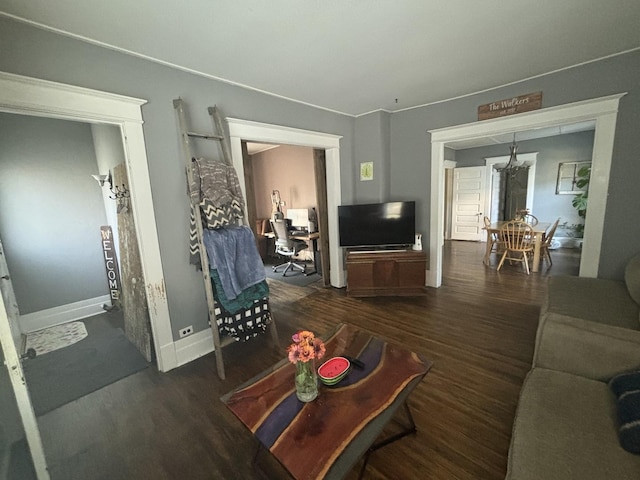 living room with a chandelier and dark hardwood / wood-style flooring