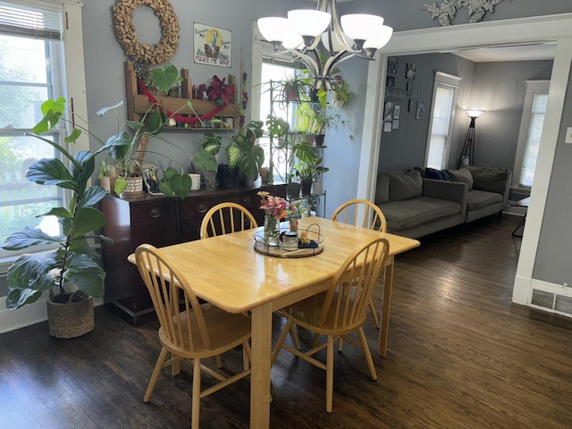 dining area featuring a chandelier, dark hardwood / wood-style flooring, and a wealth of natural light