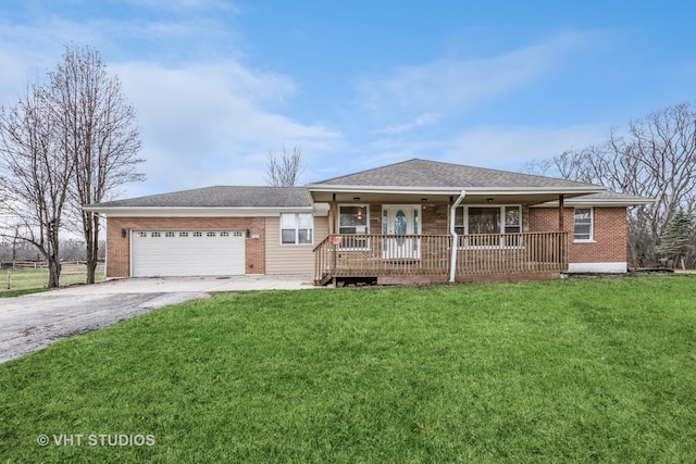 ranch-style house with covered porch, a garage, and a front lawn