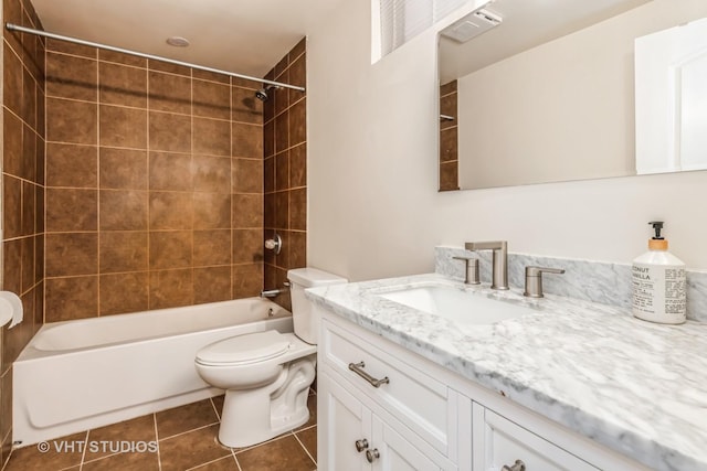 full bathroom featuring tile patterned floors, toilet, vanity, and tiled shower / bath