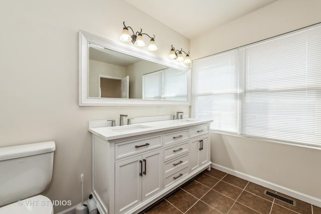 bathroom with tile patterned floors, vanity, and toilet