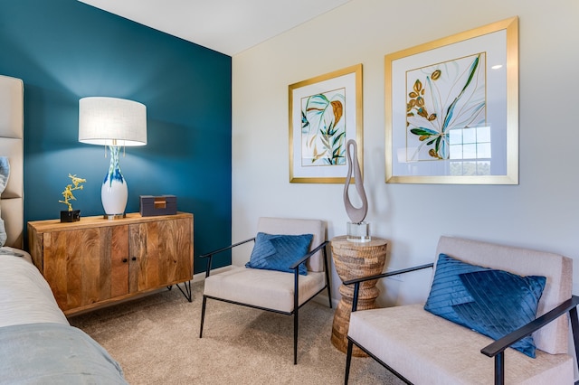 sitting room featuring light colored carpet