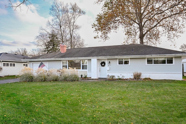 ranch-style home featuring a front yard and a garage