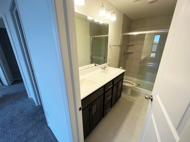 bathroom featuring tile patterned floors, toilet, an enclosed shower, and vanity