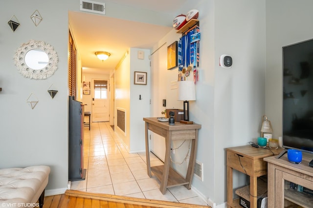 hall featuring light tile patterned flooring