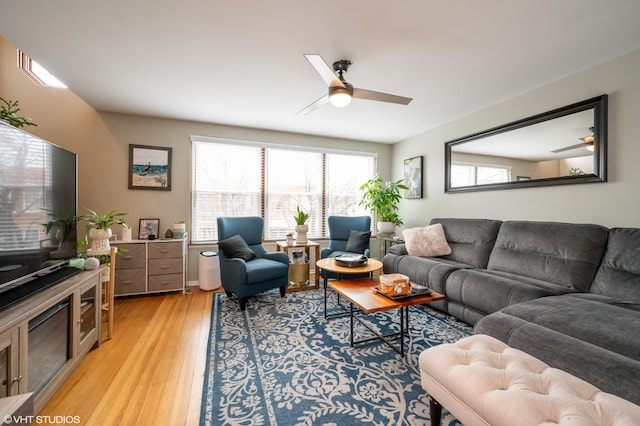 living room featuring ceiling fan and light wood-type flooring