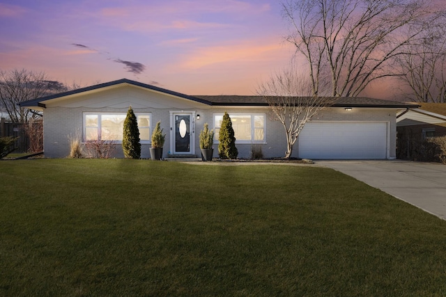 ranch-style home with a yard and a garage