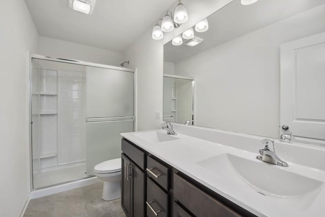 bathroom featuring an enclosed shower, vanity, and toilet