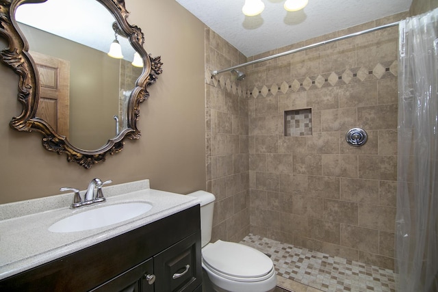 bathroom featuring vanity, toilet, and walk in shower